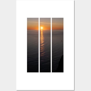 Wonderful landscapes in Norway. Nord-Norge. Beautiful scenery of a midnight sun sunset at Nordkapp (Cape North). Boat and globe on a cliff. Rippled sea and clear orange sky. (vertical) Posters and Art